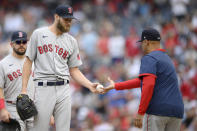 Boston Red Sox starting pitcher Chris Sale, left, is pulled from the game by manager Alex Cora, right, during the third inning of a baseball game against the Washington Nationals, Sunday, Oct. 3, 2021, in Washington. (AP Photo/Nick Wass)