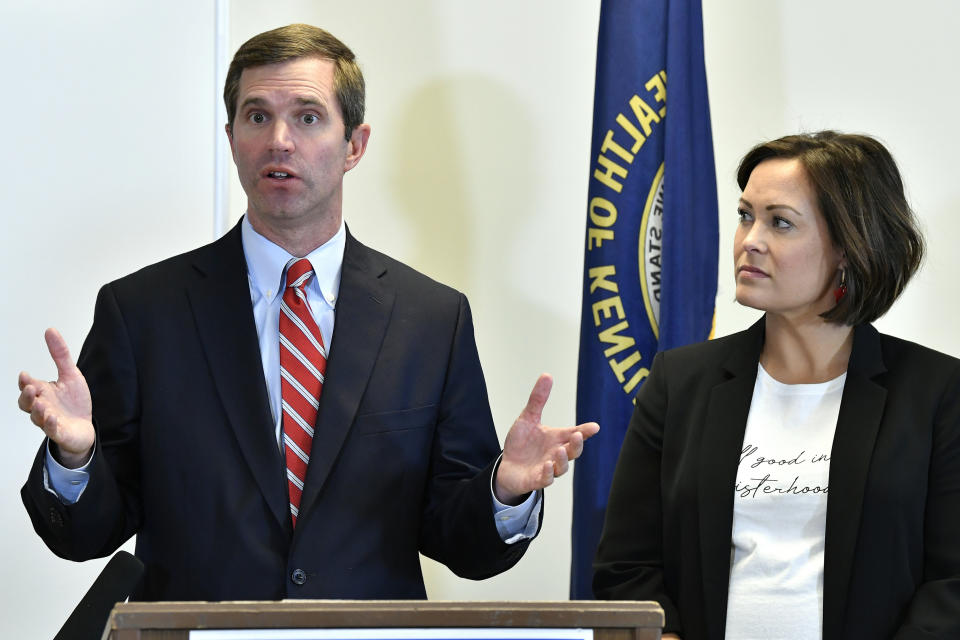 Kentucky Governor-Elect Andy Beshear, left, and his Lt. Governor Jacqueline Coleman speak with reporters following the concession of incumbent Governor Matt Bevin in Frankfort, Ky., Thursday, Nov. 14, 2019. In a recanvass, Beshear defeated Bevin by 5136 votes. (AP Photo/Timothy D. Easley)