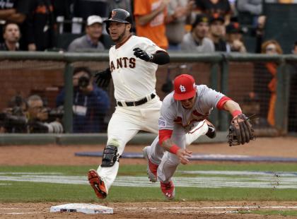 Gregor Blanco (left) laid down the bunt that led to the errant throw and the winning run. (AP)