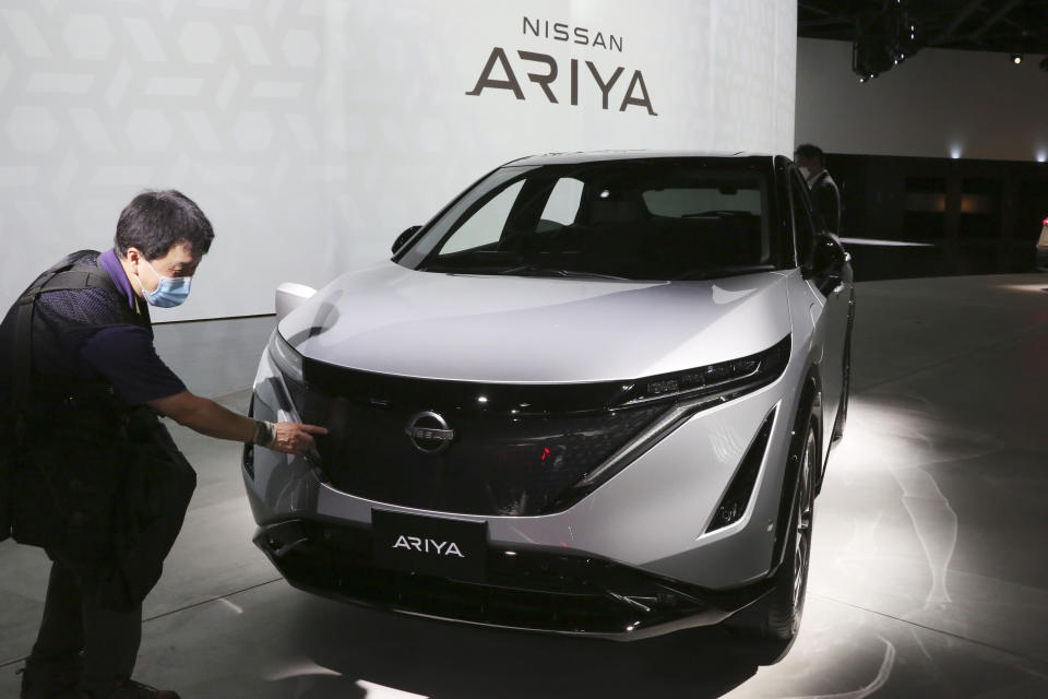 Nissan Motor Co.'s new electric crossover Ariya is displayed for media at Nissan Pavilion in Yokohama near Tokyo Tuesday, July 14, 2020. The Ariya is the Japanese automaker’s first major all-new model since getting embroiled in the scandal surrounding former Chairman Carlos Ghosn. The vehicle, set to go on sale in Japan by the middle of next year, and in Europe, North America and China by the end of 2021, costs about 5 million yen ($46,000). (AP Photo/Koji Sasahara)