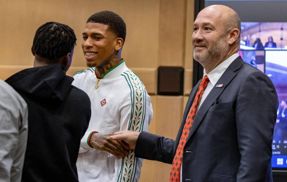 Fort Lauderdale, Florida, December 8, 2023 - Rapper NLE Choppa, whose real name is Bryson Potts, center, shakes hands with his attorney, Brad Cohen, right, as he talks to a co-defendant in the case, left, before Judge Barbara Duffy in courtroom 6900 at the Broward County Courthouse in Fort Lauderdale, Florida