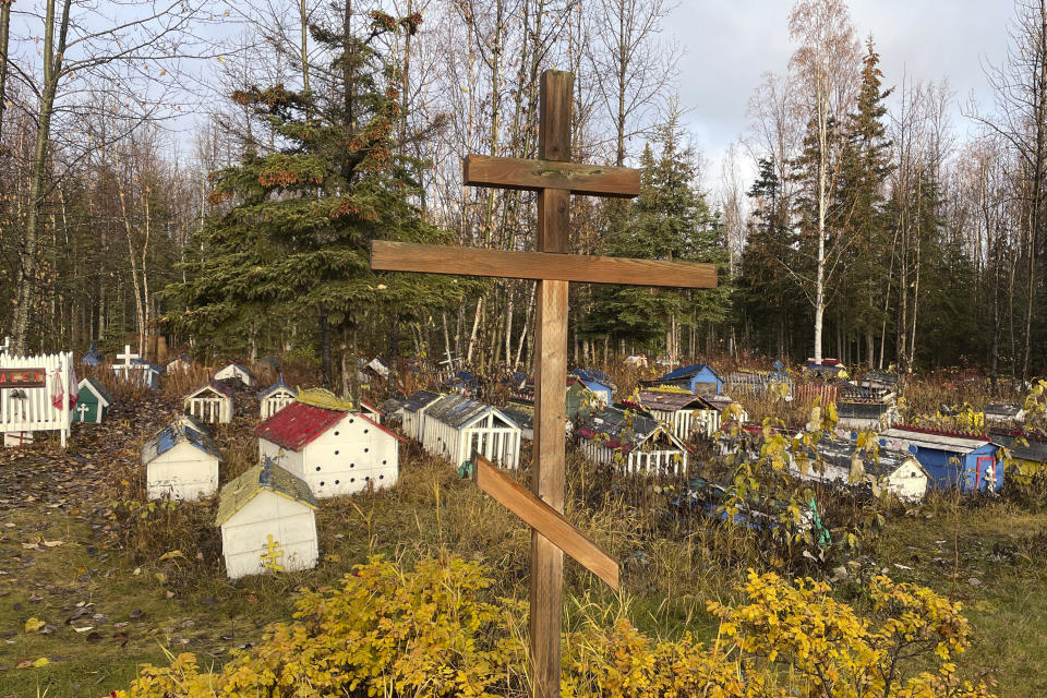 The cemetery at St. Nicholas Church in Eklutna, Alaska, features a mixture of Russian Orthodox conventions like crosses featuring three cross beams and the Dena'ina Athabascan tradition of erecting spirit homes above the graves, on Oct. 13, 2023. A restoration effort has begun on the old St. Nicholas Church, which is the oldest standing building in the Municipality of Anchorage. (AP Photo/Mark Thiessen)