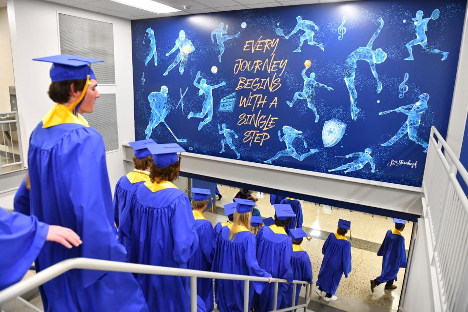 Students make their way into the north gym for the Cathedral High School graduation ceremony Friday, May 27, 2022, in St. Cloud.