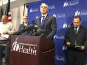 Washington Gov. Jay Inslee, center, speaks Tuesday Jan. 21, 2020, at a news conference in Shoreline, Wash., following the announcement that a man in Washington state is the first known person in the United States to catch a new type of coronavirus that officials believe originated in China. The man who caught the virus is a Washington state resident who returned last week from China and is currently hospitalized near Seattle. (AP Photo/Carla K. Johnson)