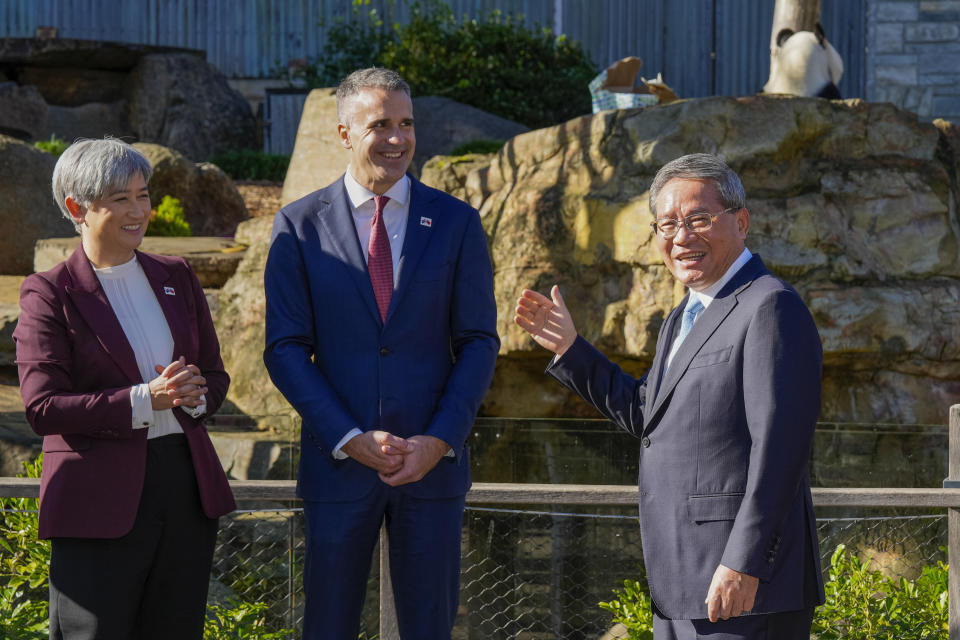 China's Premier Li Qiang, right, gestures as Penny Wong, left, Australia's foreign minister, and South Australian Premier Peter Malinauskas, center, visit Adelaide Zoo, Australia, Sunday, June 16, 2024. Li is on a relations-mending mission with panda diplomacy, rock lobsters and China's global dominance in the critical minerals sector high on the agenda during his four-day visit to Australia. (Asanka Brendon Ratnayake/Pool Photo via AP)