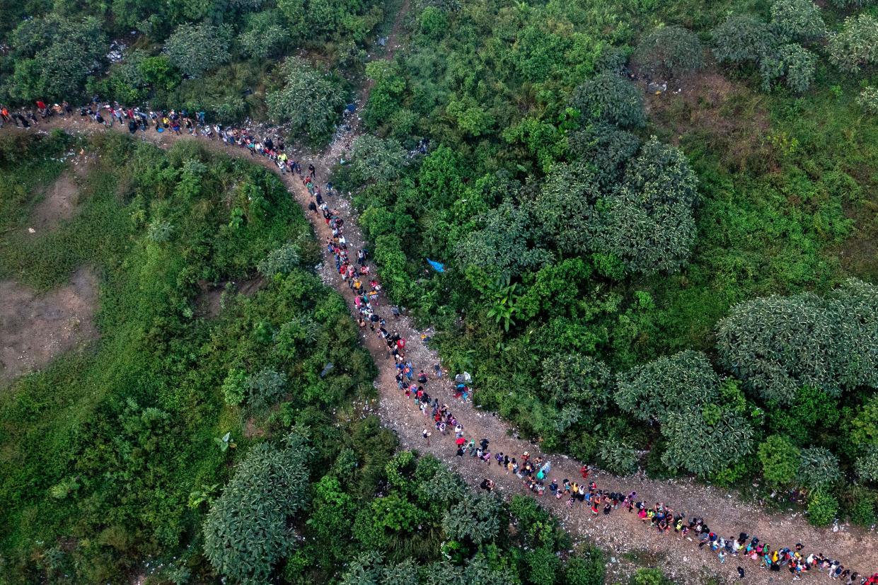 Aerial view showing migrants walking through the jungle near Bajo Chiquito village, the first border control of the Darien Province in Panama, on September 22, 2023.  / Credit: LUIS ACOSTA/AFP via Getty Images