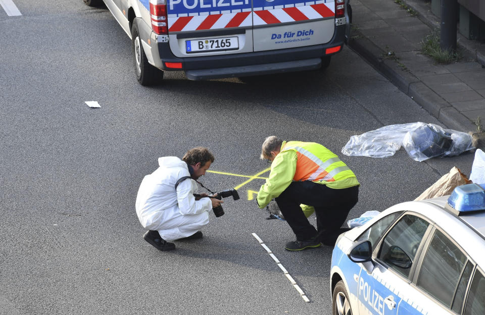 Investigators work on the scene following several accidents on the city motorway A100 in Berlin, Germany, Wednesday, Aug. 19, 2020. According to German news agency dpa, prosecutors say a series of crashes caused by a 30-year-old Iraqi man on the highway late Tuesday night was an Islamic extremist attack. (Paul Zinken/dpa via AP)