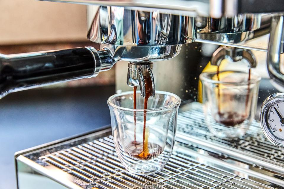 espresso dripping into glass cup