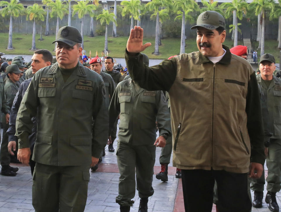 FILE - In this May 2, 2019 photo released by the Miraflores Press Office, Venezuela's President Nicolas Maduro, right, accompanied by his Defense Minister Vladimir Padrino, waves upon his arrival to Fort Tiuna, in Caracas, Venezuela. Venezuelan military officials said Saturday, Dec. 30, 2023, that they will continue to deploy nearly 6,000 troops until a British military vessel sent to neighboring Guyana leaves the waters off the coast of the two South American nations. (Jhonn Zerpa/Miraflores Press Office via AP File)