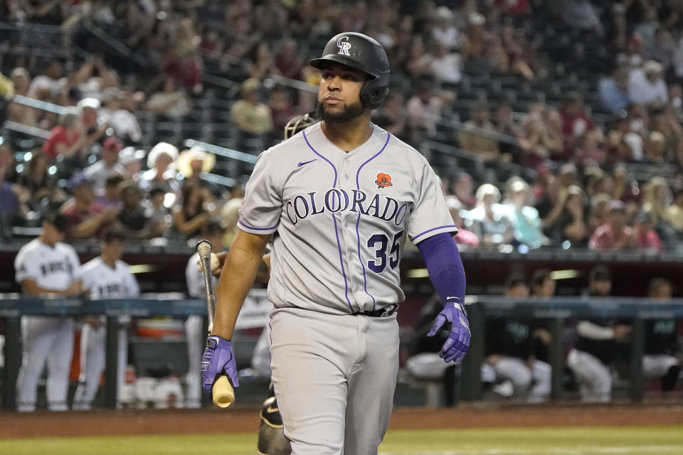 Colorado Rockies' Elias Diaz walks to the dugout after striking out against the Arizona Diamondbacks during the ninth inning of a baseball game, Monday, May 29, 2023, in Phoenix. (AP Photo/Darryl Webb)