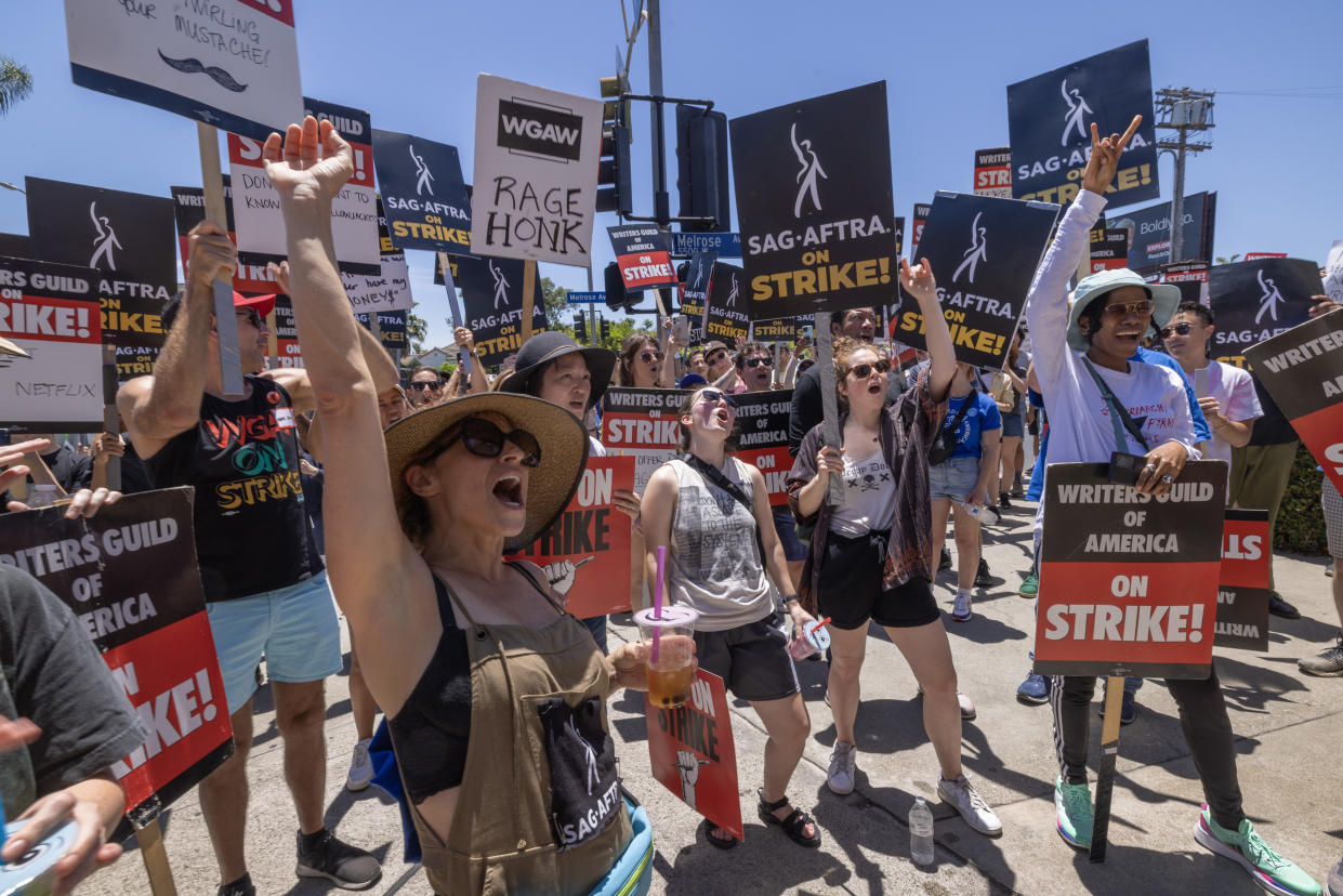 Members of the Hollywood actors SAG-AFTRA union walk a picket line with screenwriters outside of Paramount Studios