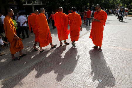 Monks leave after voting inside a polling station during a general election in Phnom Penh, Cambodia July 29, 2018. REUTERS/Darren Whiteside