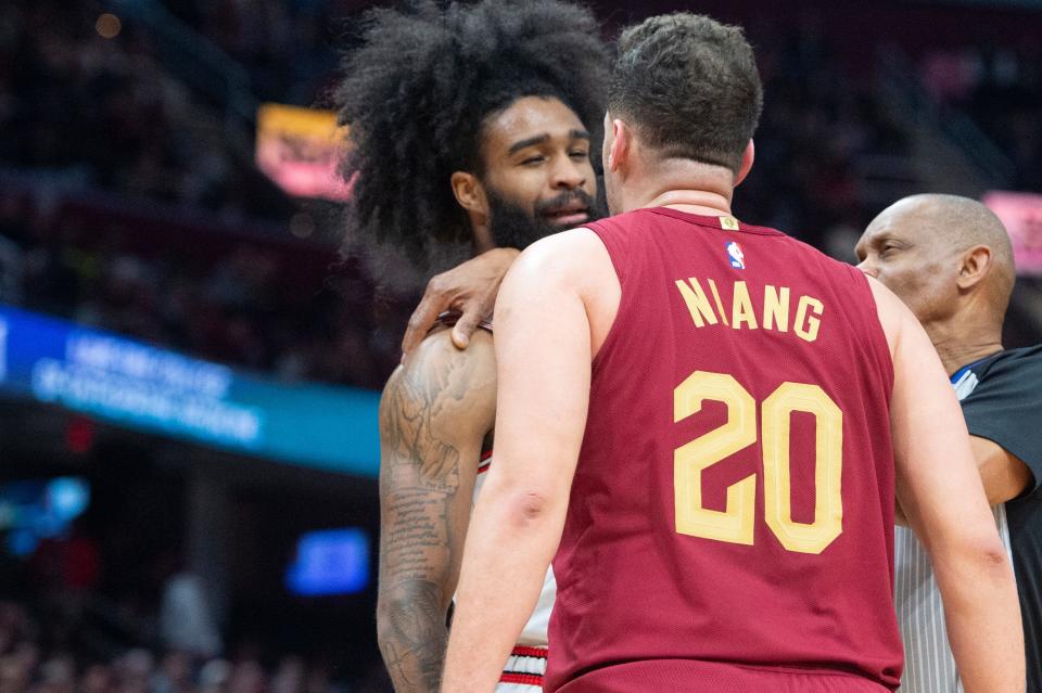 Referee Michael Smith separates Chicago Bulls' Coby White left, and Cleveland Cavaliers' Georges Niang (20) during the second half Wednesday in Cleveland.