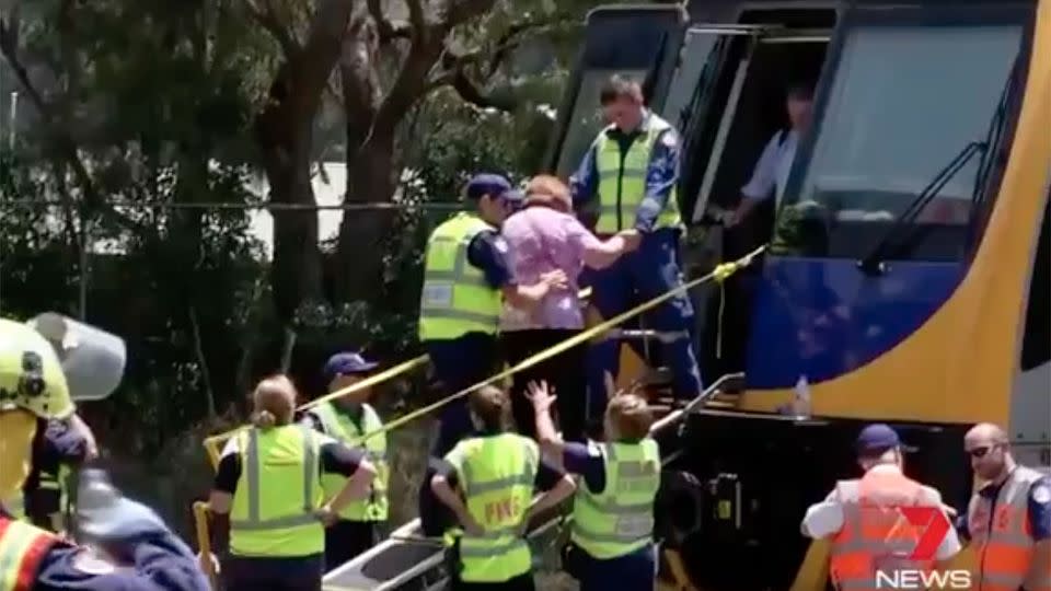 Emergency service workers helped escort passengers from the northbound train at the scene. Source: 7 News