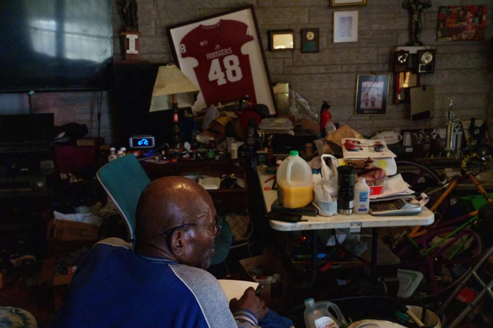 Donald Silas, a former Manuel High School football star and one of the "IU10," makes housing arrangements Tuesday, Feb. 6, 2024, inside his Indianapolis home after being diagnosed with a terminal illness. The IU 10 was a group of Black players who left the IU football team, boycotting against unequal treatment because of their race. Silas says the group who left the team never were able to reach their full potential in life. Silas says he filled the void left by the boycott with teaching and bodybuilding.