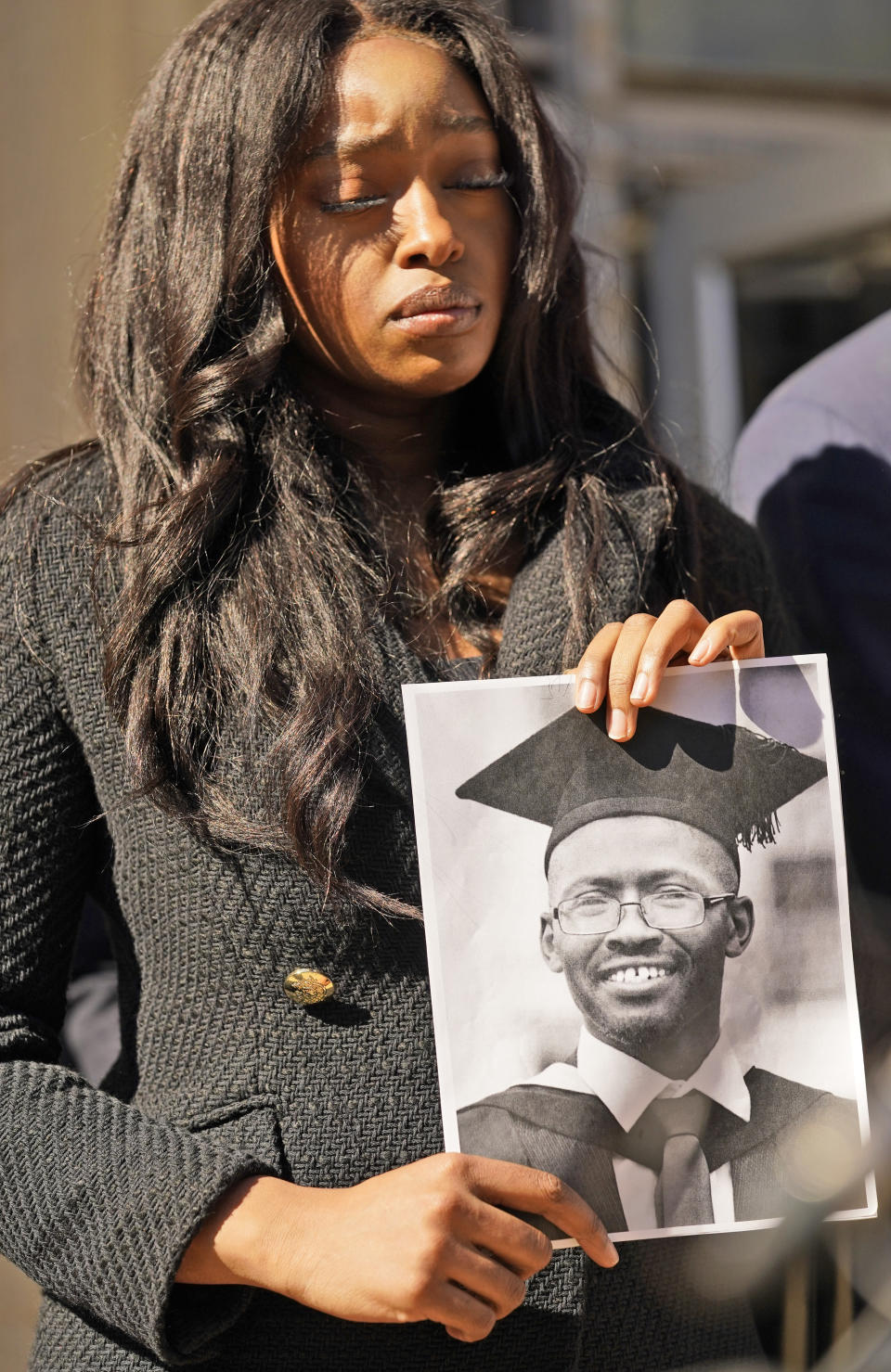 Zipporah Kuria, of London, holds a photo of her deceased father Joseph Waithaka, as she stands outside federal court after the Boeing arraignment hearing in Fort Worth, Texas, Thursday, Jan. 26, 2023. Waithaka was killed in 2019 crash of a Boeing 737 Max airliner. (AP Photo/LM Otero)
