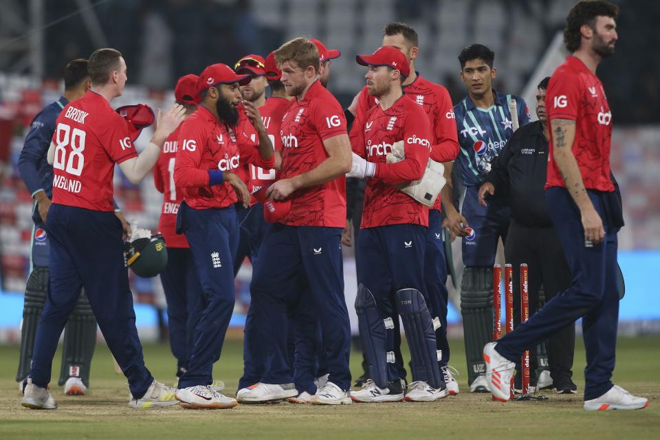 England's players congratulate each other after winning the seventh twenty20 cricket match against Pakistan, in Lahore, Pakistan, Sunday, Oct. 2, 2022. (AP Photo/K.M. Chaudary)