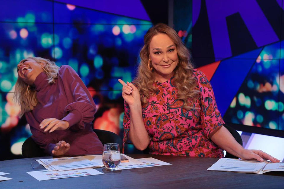 Carrie Bickmore laughing with Kate Langbroek pointing towards her on The Project