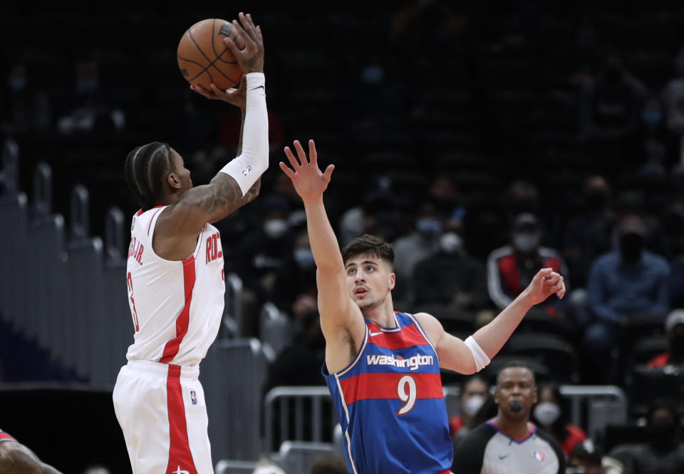 Houston Rockets' Kevin Porter Jr. shoots as Washington Wizards' Deni Avdija (9) defends during the first half of an NBA basketball game Wednesday, Jan. 5, 2022, in Washington. (AP Photo/Luis M. Alvarez)