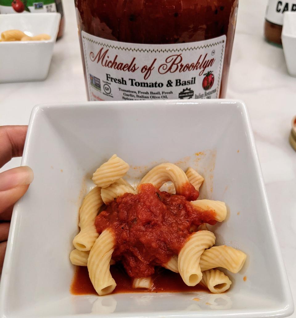 jar of michaels of brooklyn red sauce behind a small white bowl of pasta