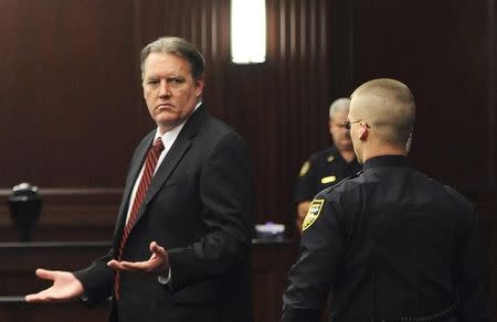 Michael Dunn raises his hands in disbelief as he looks toward his parents after the verdicts were announced in his trial in Jacksonville, Florida February 15, 2014. REUTERS/Bob Mack/Florida Times-Union/Pool