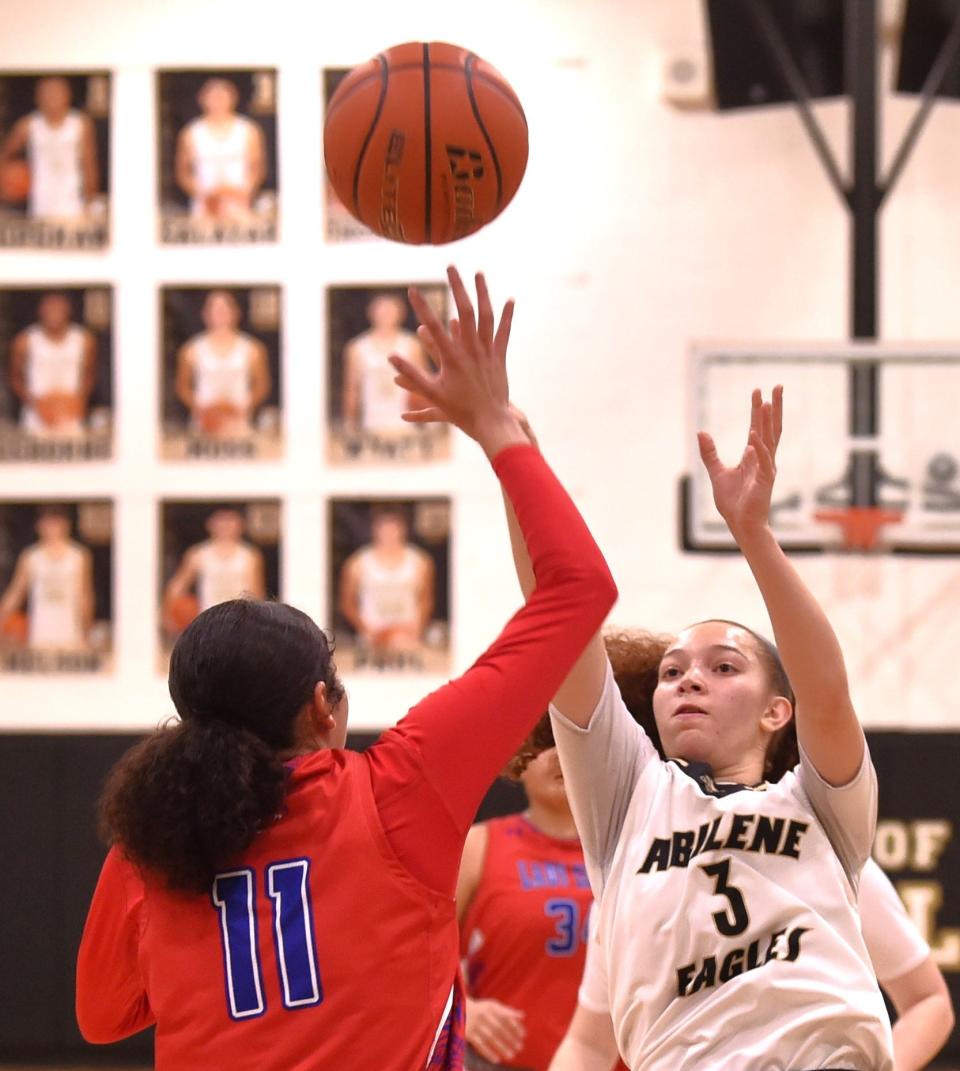 Abilene High's Samia Cooper (3) shoots over Abilene Cooper's Jayda Jones in the first half. The Lady Eagles beat Cooper 43-34 in the District 4-5A girls basketball game Friday at Eagle Gym.