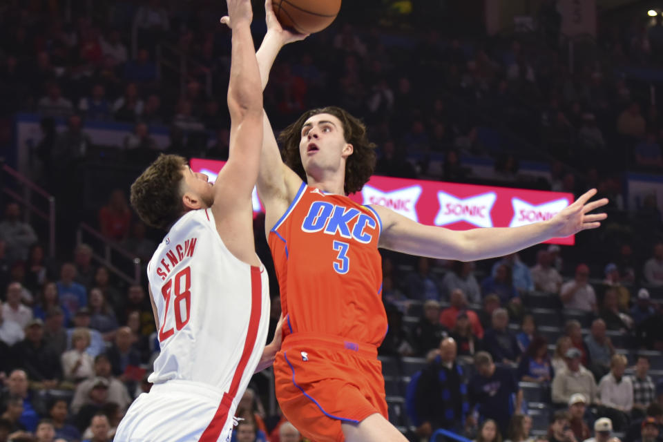 Oklahoma CIty Thunder guard Josh Giddey (30 shoots over Houston Rockets center Alperen Sengun (28) in the first half of an NBA basketball game, Tuesday, Feb. 27, 2024, in Oklahoma City. (AP Photo/Kyle Phillips)