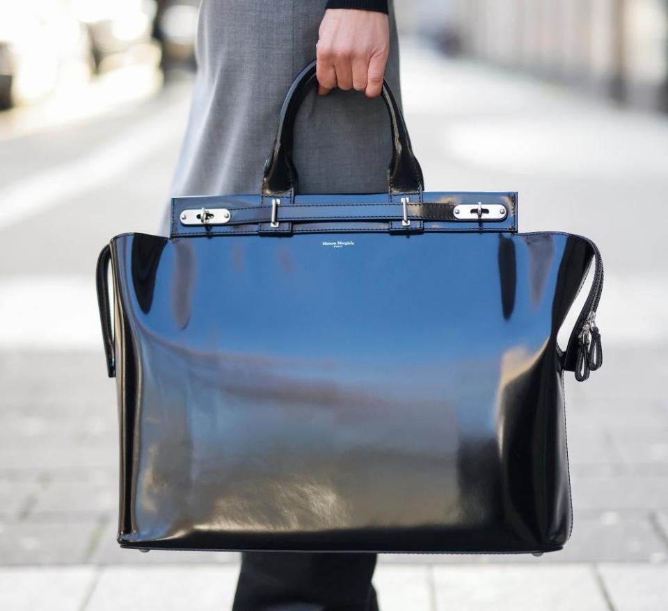 A oversize shiny black bag by Maison Margiela as a detail of Influencer Gitta Banko during a street style shooting on December 20, 2020 in Duesseldorf, Germany. (Photo by Streetstyleshooters/Getty Images)