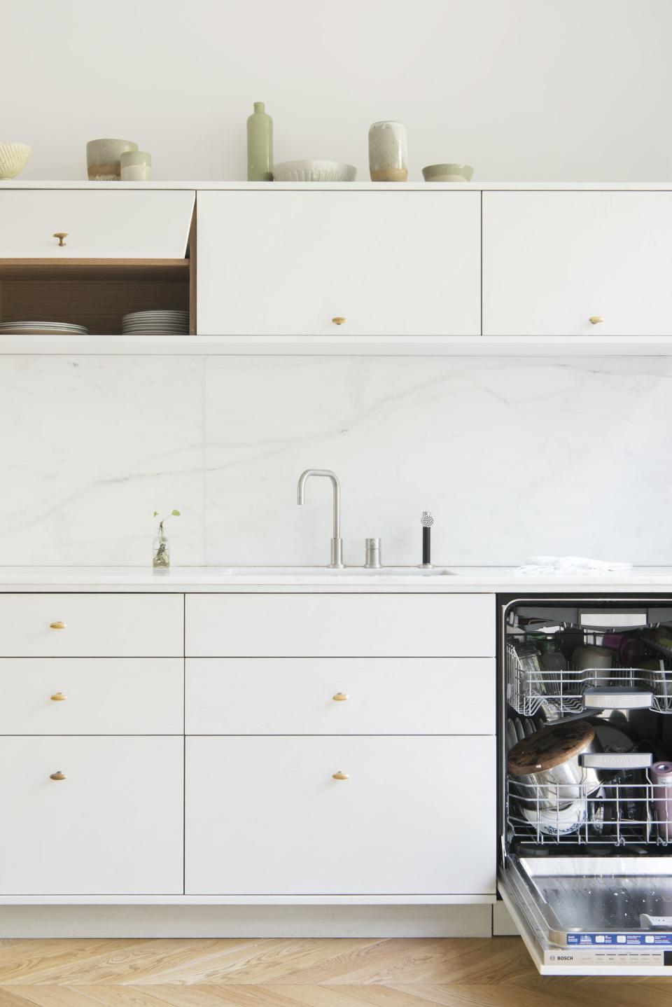 Roberts intentionally designed shallow upper cabinets that open from the bottom for easy access. "Once you open them, they remain open until you shut them, and when they’re shut, they’re completely out of the way."