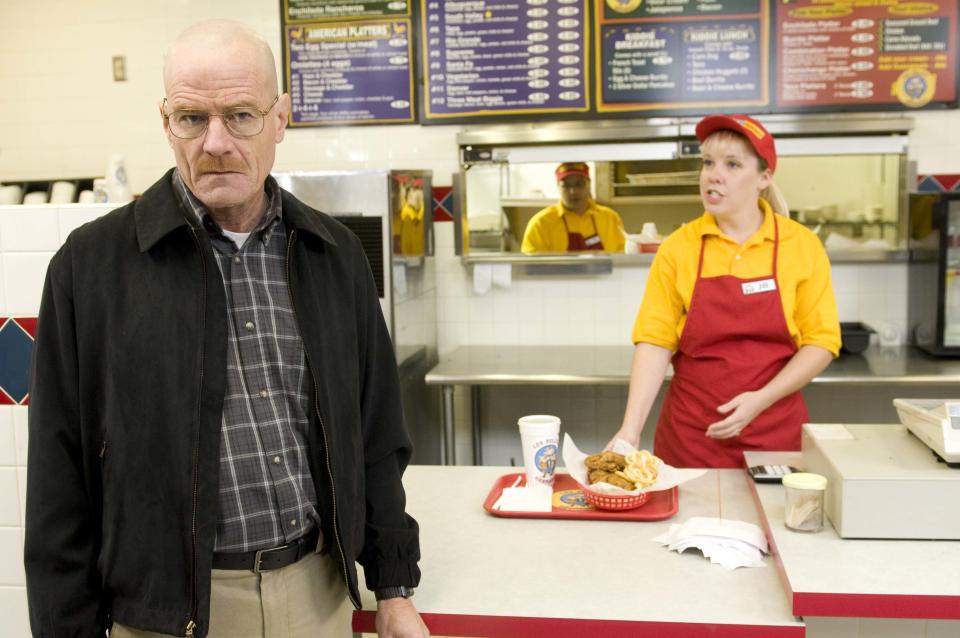 This image released by AMC shows Bryan Cranston as Walter White at the fictional restaurant "Los Pollos Hermanos" in a scene from season 2 of the AMC series "Breaking Bad." A Twisters burrito restaurant in Albuquerque that serves as the location for the restaurant has become an international tourist attraction as people come from all over the world to see the spot where a fictional drug trafficker runs his organization. (AP Photo/AMC)