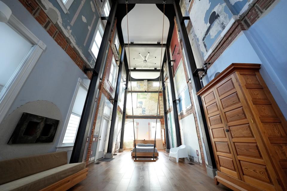 General view of an Airbnb rental property known as the Swing House, featuring a large swing hung from the ceiling, in the industrial neighborhood of Camp Washington in Cincinnati, pictured, Thursday, Dec. 2, 2021. The Italianate, three-story home built in 1880 has been converted into one massive, wide-open room.