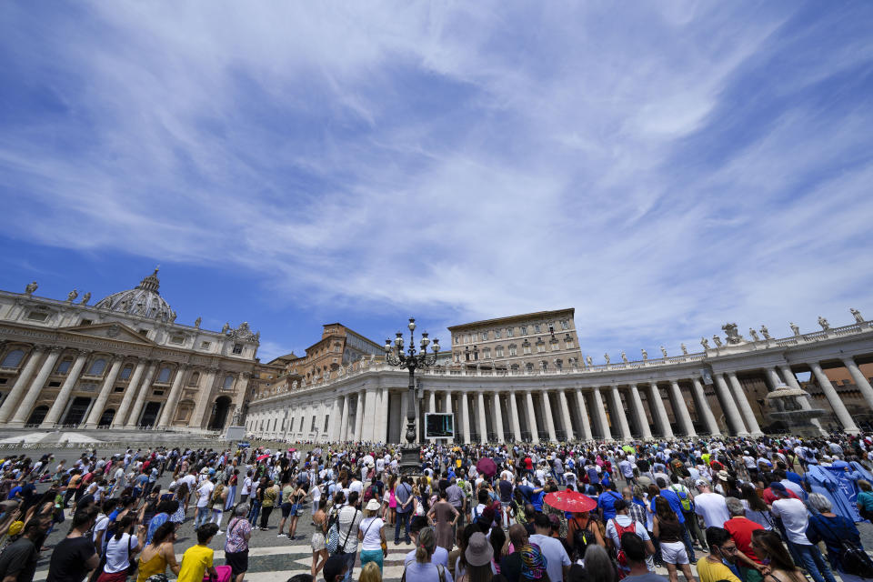 People crowd St.Peter's Square, at the Vatican, as Pope Francis recites the Angelus noon prayer from the window of his studio, top right,, Sunday, June 13, 2021. Francis demanded during his speech for humanitarian aid to reach residents of the war-torn Tigray region of northern Ethiopia, where Ethiopian and Eritrean soldiers are blocking food and other assistance. (AP Photo/Andrew Medichini)