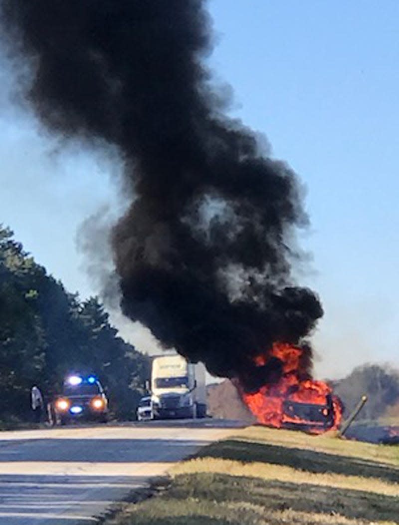 A car burns on Highway 80 East in Matthews after a man and his son flee the vehicle.