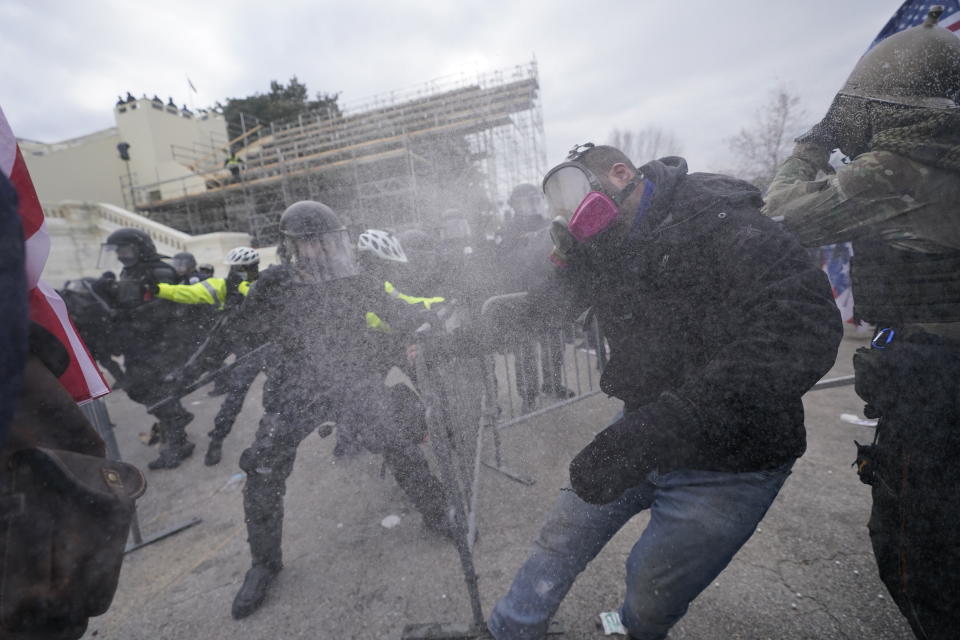 Trump supporters try to break through a police barrier, Wednesday, Jan. 6, 2021, at the Capitol in Washington. (AP Photo/Julio Cortez)