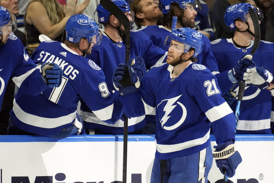 Tampa Bay Lightning center Brayden Point (21) celebrates with the bench after his goal against the St. Louis Blues during the first period of an NHL hockey game Friday, Nov. 25, 2022, in Tampa, Fla. (AP Photo/Chris O'Meara)