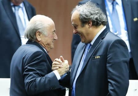 UEFA President Michel Platini (R) congratulates FIFA President Sepp Blatter after he was re-elected at the 65th FIFA Congress in Zurich, Switzerland, May 29, 2015. S REUTERS/Arnd Wiegmann