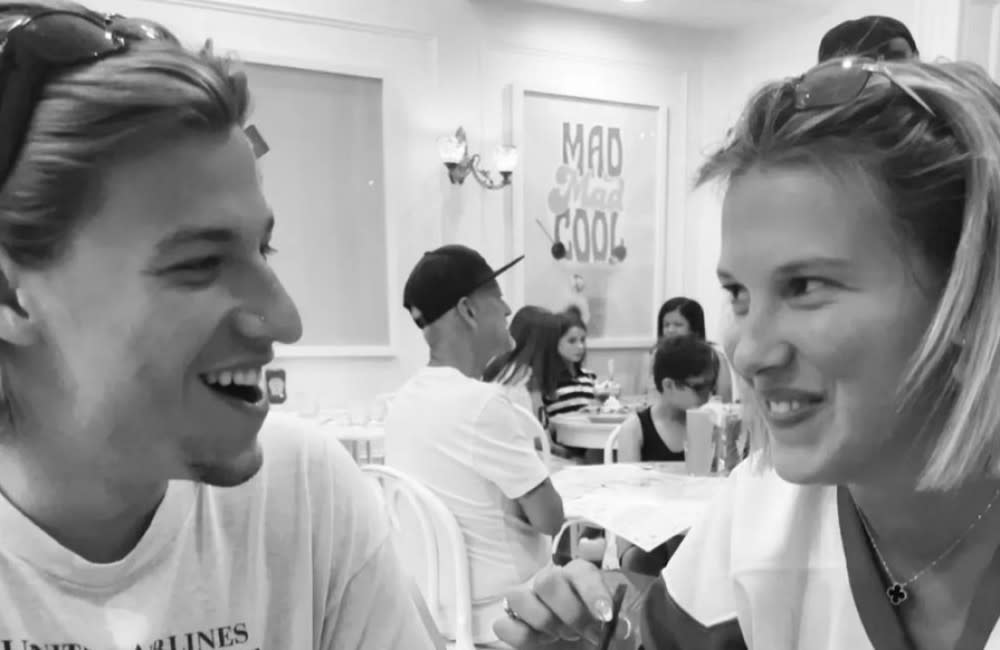 Millie Bobby Brown flashed a ‘mystery gold ring’ on her wedding finger while kissing boyfriend Jake Bongiovi credit:Bang Showbiz