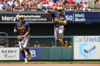 Milwaukee Brewers second baseman Kolten Wong, right, is unable to throw out St. Louis Cardinals' Tommy Edman at first as Brewers shortstop Willy Adames (27) watches during the seventh inning of a baseball game Sunday, Aug. 14, 2022, in St. Louis. (AP Photo/Jeff Roberson)