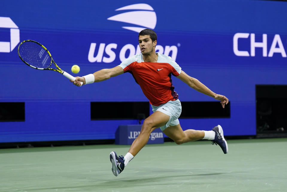 Carlos Alcaraz, of Spain, returns a shot to Frances Tiafoe, of the United States, during the semifinals of the U.S. Open tennis championships, Friday, Sept. 9, 2022, in New York. (AP Photo/John Minchillo)