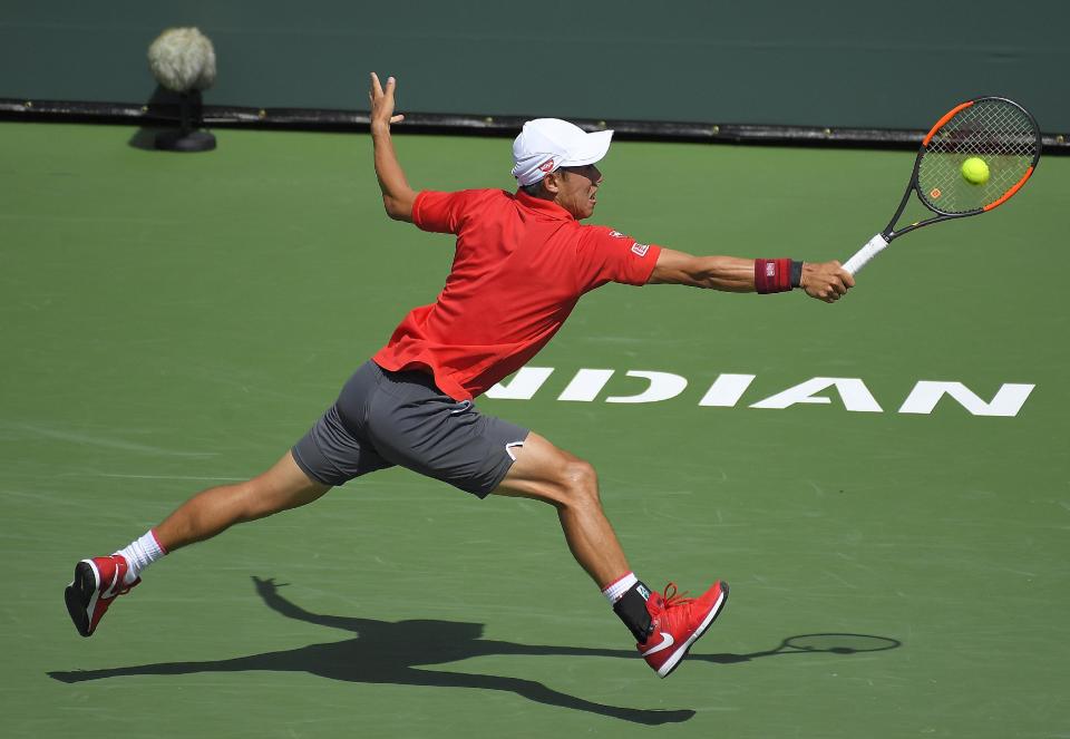 Kei Nishikori, of Japan, returns a shot to Donald Young at the BNP Paribas Open tennis tournament, Wednesday, March 15, 2017, in Indian Wells, Calif. (AP Photo/Mark J. Terrill)