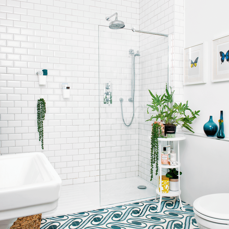 White bathroom with walk in shower and house plants