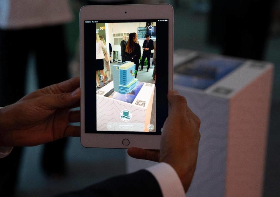 A attendee looks at an augmented reality scan of the building during a ceremony celebrating the $50 million donation by Ken Griffin, Citadel CEO, for a new building called the Kenneth C. Griffin Cancer Research Building on Tuesday, March 5, 2024, on the campus of the University of Miami Miller School of Medicine in Miami. Alie Skowronski/askowronski@miamiherald.com