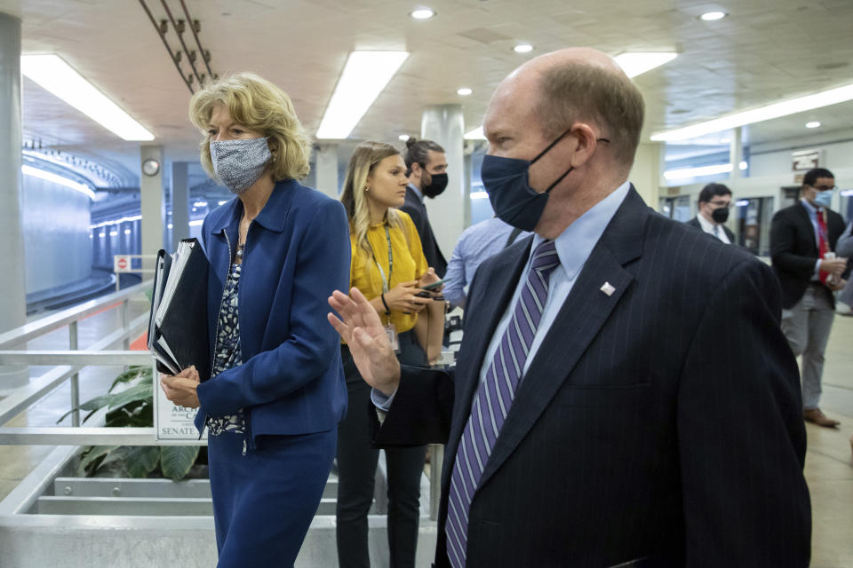 Sen. Lisa Murkowski, R-Alaska, speaks to Sen. Chris Coons, D-Del., amid continuing talks around the $1 trillion bipartisan infrastructure bill on Capitol Hill in Washington, Tuesday, Aug. 3, 2021. (AP Photo/Amanda Andrade-Rhoades)