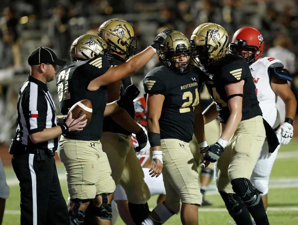 Lubbock High’s Keith Ramirez (24) is congratulated by teammates after scoring a touchdown in the first half of their game against Plainsview at Lowrey Field at PlainsCapital Park on Friday, Sept. 10, 2021.