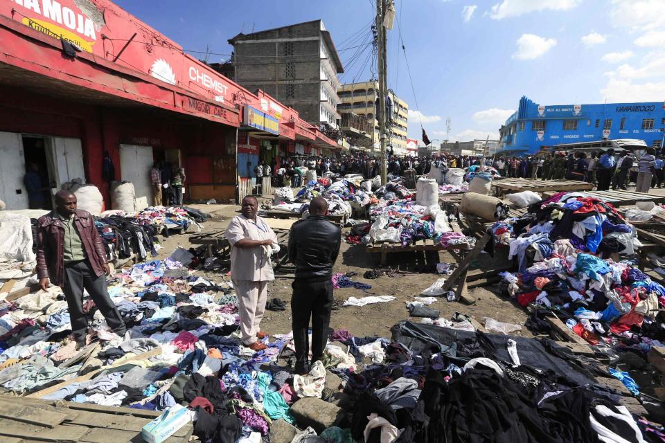 Kenyan forensic experts work at the scene of a twin explosion at the Gikomba open-air market for second-hand clothes in Kenya's capital Nairobi May 16, 2014. (REUTERS/Noor Khamis)