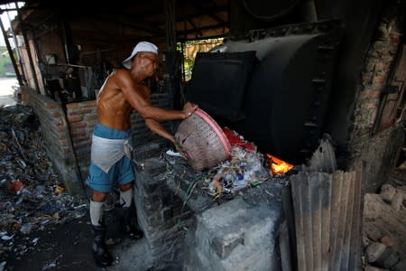 The Wider Image: Cash for trash: Indonesia village banks on waste recycling