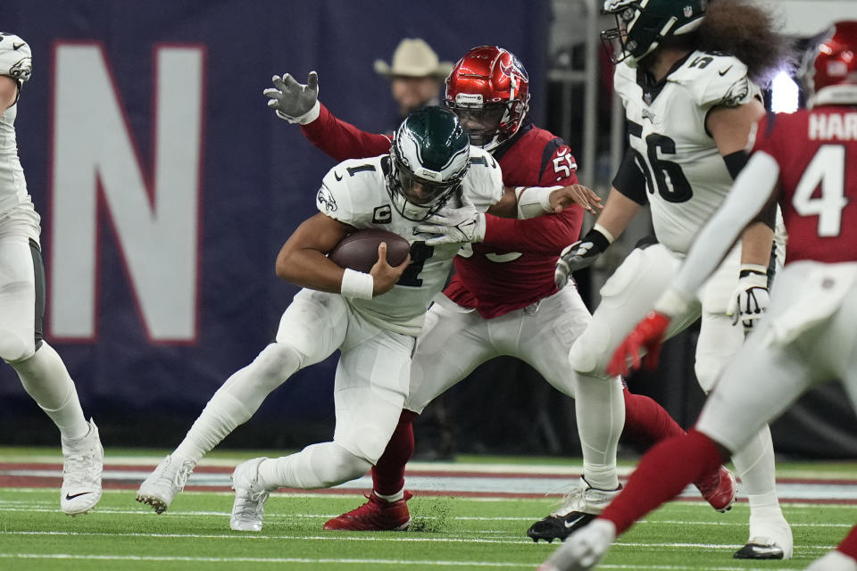 Philadelphia Eagles quarterback Jalen Hurts (1) is brought down by Houston Texans defensive end Jerry Hughes (55) in the second half of an NFL football game in Houston, Thursday, Nov. 3, 2022. (AP Photo/Eric Christian Smith)