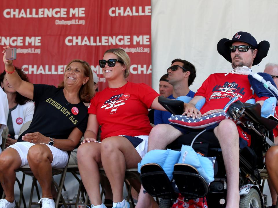 Nancy Frates, wearing a black T-shirt, sits alongside other members of her family, including her late son, Pete Frates, who inspired the ALS Ice Bucket Challenge.