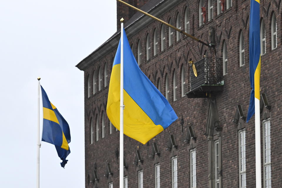 The flag of Ukraine waves at Stockholm City Hall, Sweden, Thursday, Feb. 24, 2022. Russia launched a wide-ranging attack on Ukraine on Thursday, hitting cities and bases with airstrikes or shelling, as civilians piled into trains and cars to flee. Ukraine's government said Russian tanks and troops rolled across the border in a “full-scale war” that could rewrite the geopolitical order and whose fallout already reverberated around the world. (Claudio Bresciani/TT via AP)