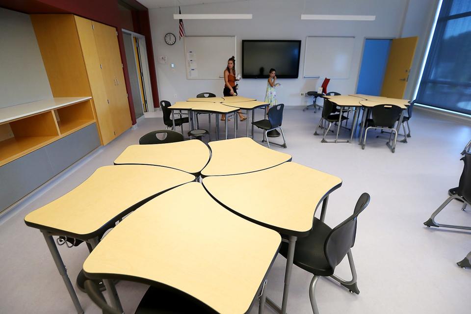 A mother and daughter walk through an eighth grade class room during a tour of the new Chapman Middle School in Weymouth on Saturday, Aug. 6, 2022.